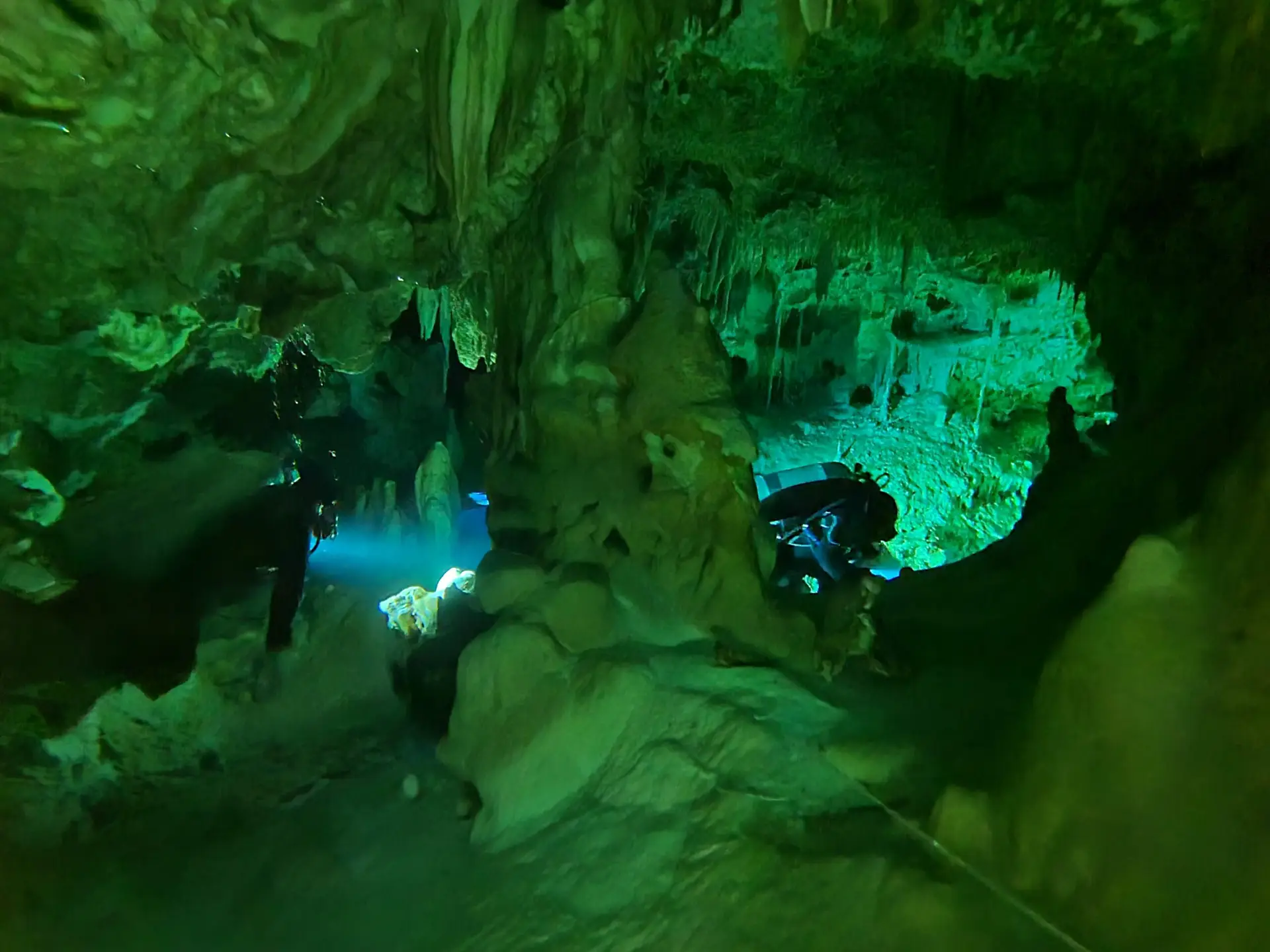 Playa del Carmen Diving Tips: 12 Things to Know Before Your Trip 2 Green-lit limestone formations inside a cenote cavern