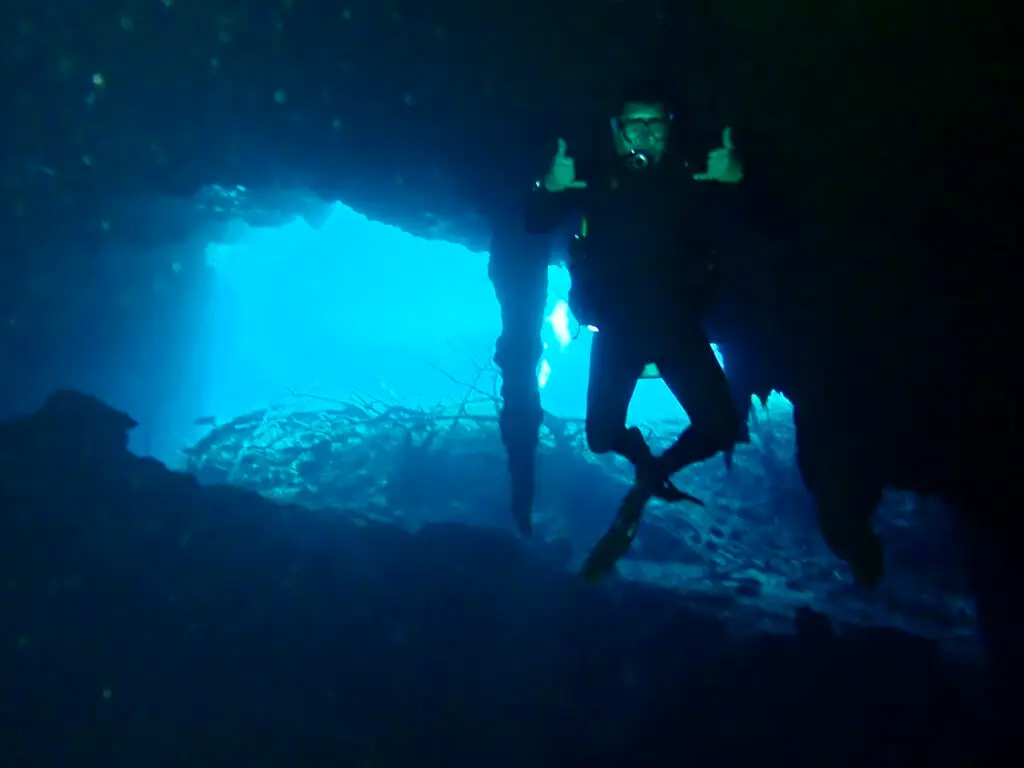 Diver at the entrance of a cenote cavern, photo by a guest