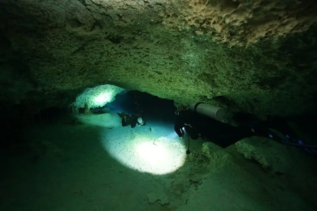 Dive lights in the dark section of the Cenote Dos Ojos cavern, where everyone carries a torch